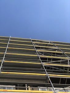 A sturdy aluminium scaffolding setup at a construction site.