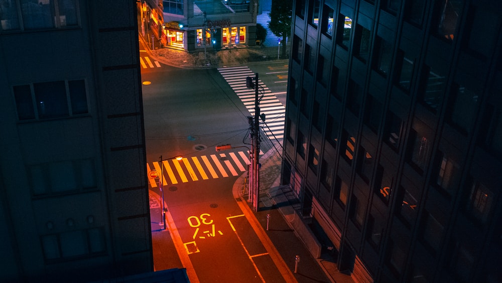 a city street at night with traffic lights