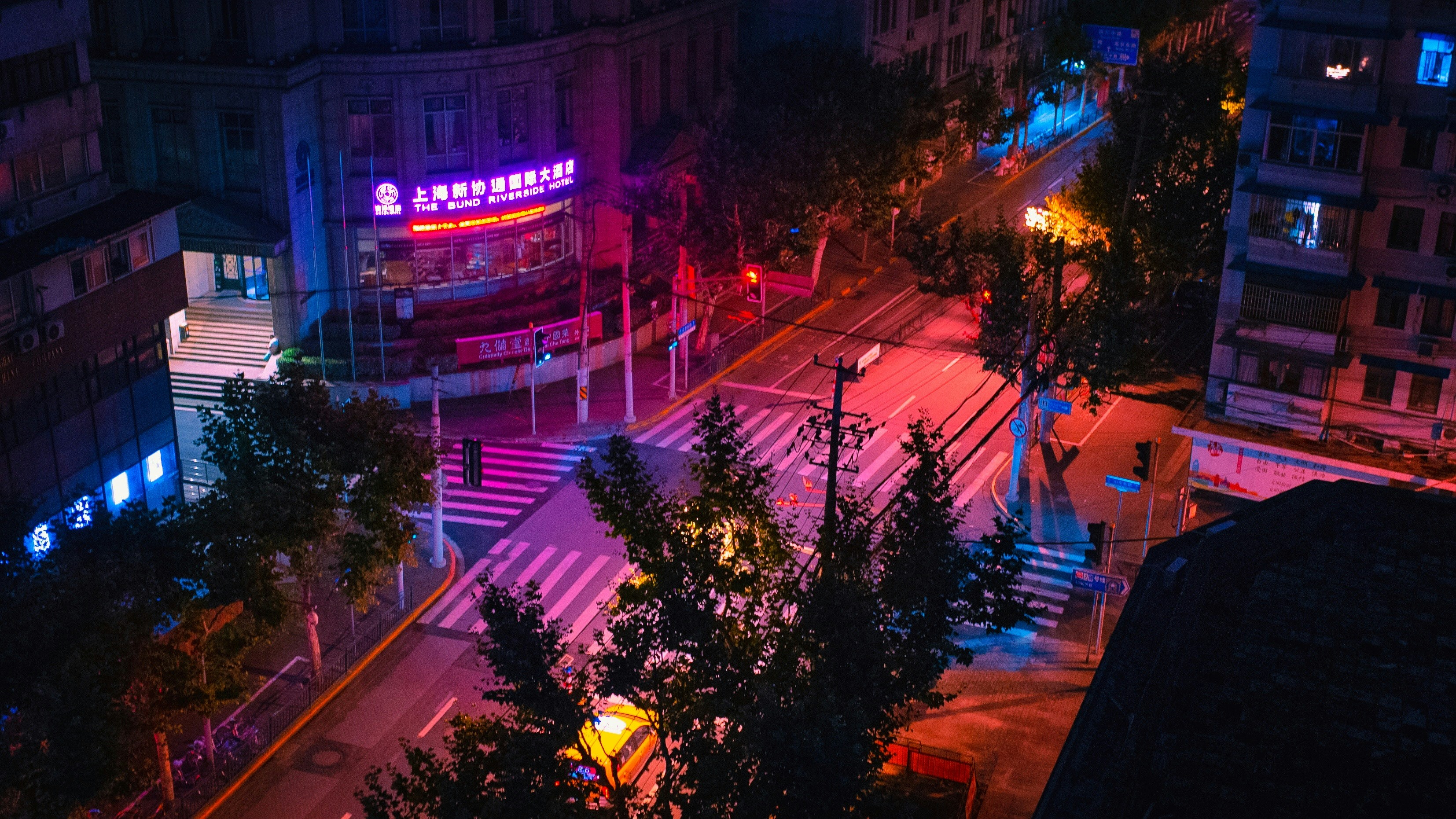 A city street at night with traffic lights photo – Free Light Image on ...