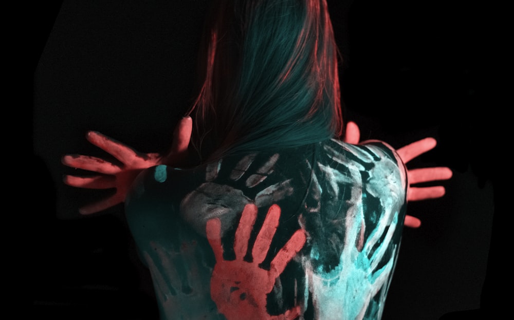 multicolored paint on woman's back