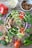 A vibrant salad bowl filled with colorful vegetables and protein sources.