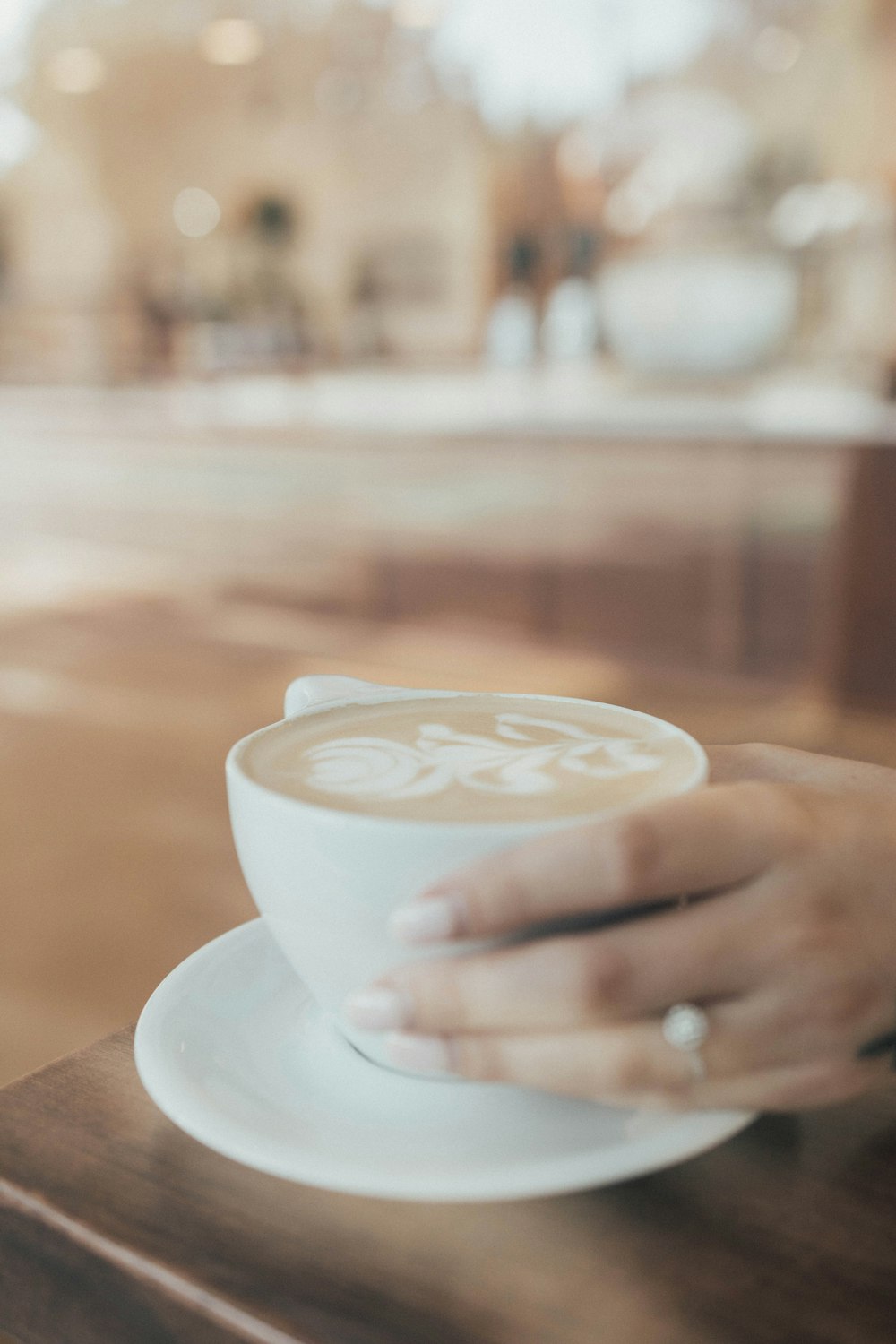 shallow focus photo of white ceramic mug and sacuer