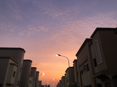 Evening shot of a residential street lined with inviting homes and soft street lighting.