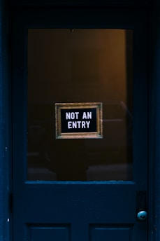 blue wooden door with not an entry signage