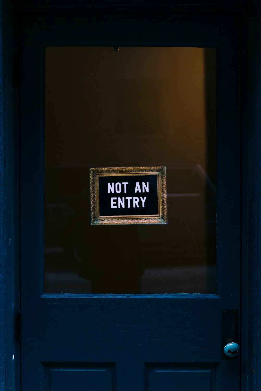 blue wooden door with not an entry signage