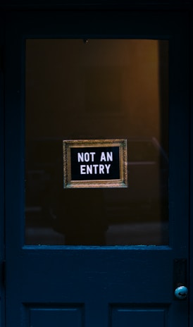 blue wooden door with not an entry signage