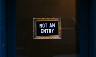 blue wooden door with not an entry signage