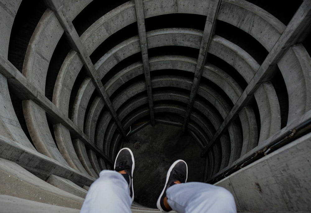 a person is standing in the middle of a tunnel