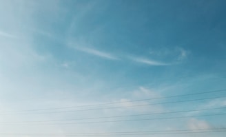 A close-up of a power line against a clear blue sky.
