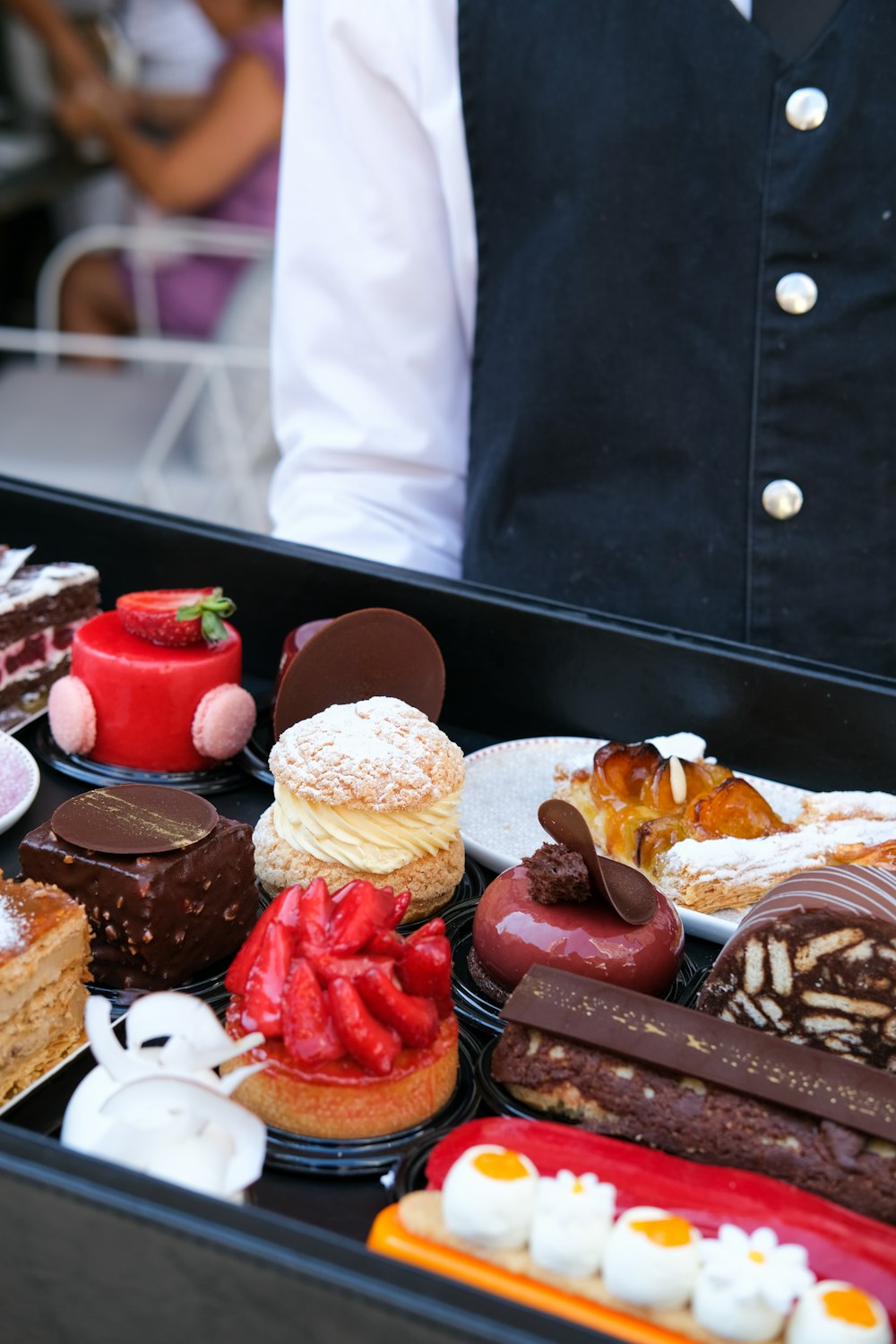 person standing beside tray of food