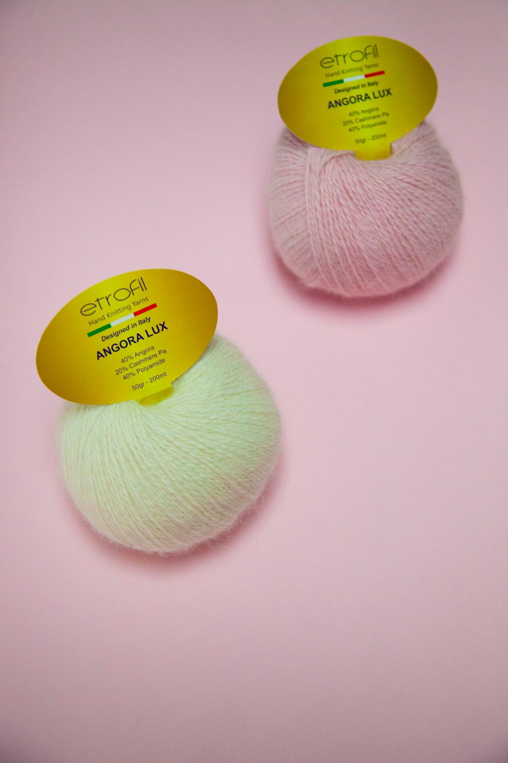 two white and pink Angora Lux yarn balls