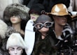 A collection of mannequin heads adorned with various hats and accessories. The hats are made from materials such as fur and leather, ranging from aviator goggles to wide-brimmed styles. Each mannequin exudes a unique character due to the distinct headwear choices, with some displaying elegant flower details and others a more vintage pilot look.
