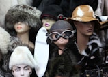 Stylish hats with various embroidered patterns showcased on mannequin heads.