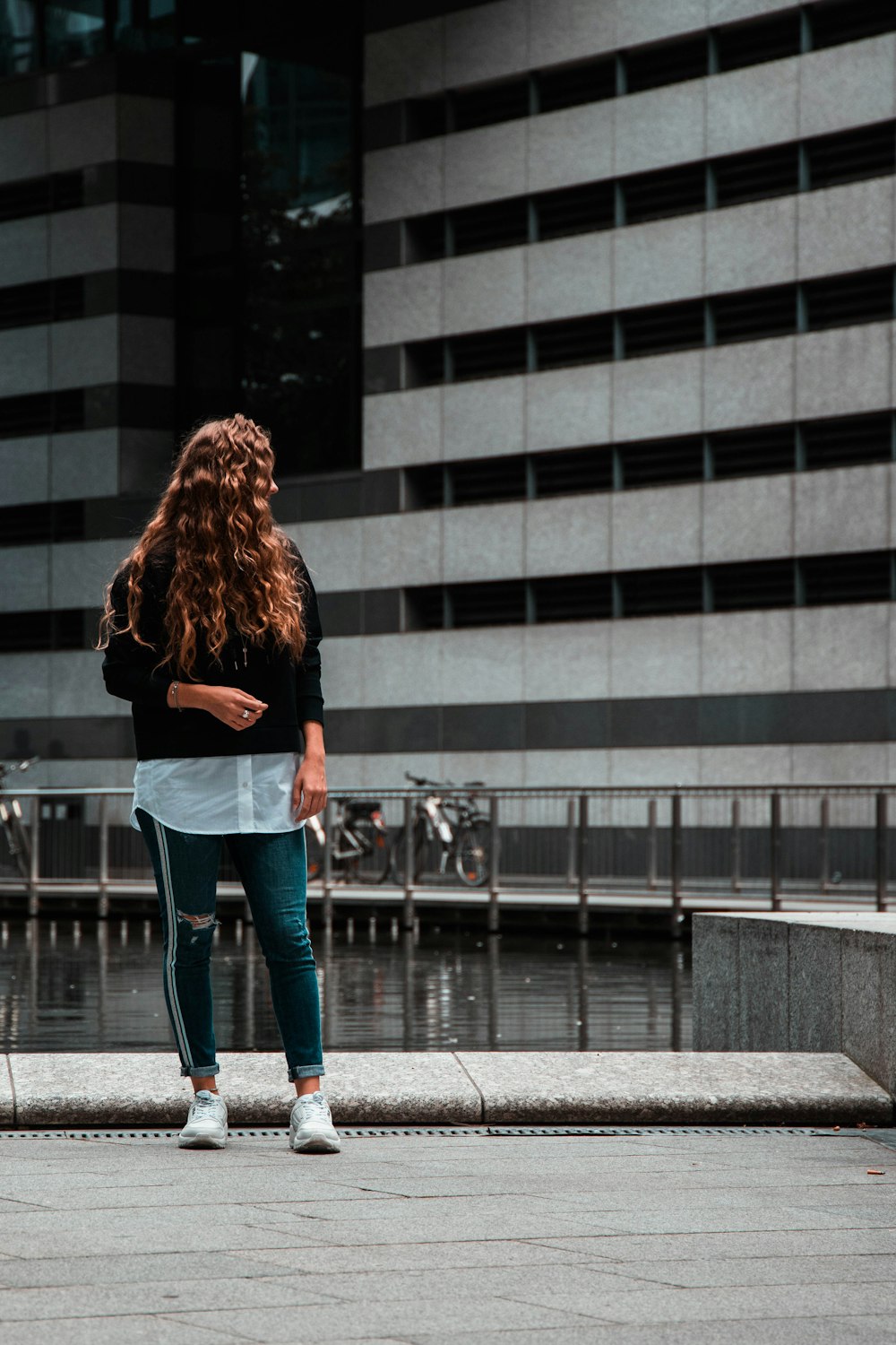 woman standing near building