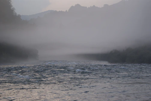 A misty morning view of the Ganges river winding through Varanasi's ancient ghats