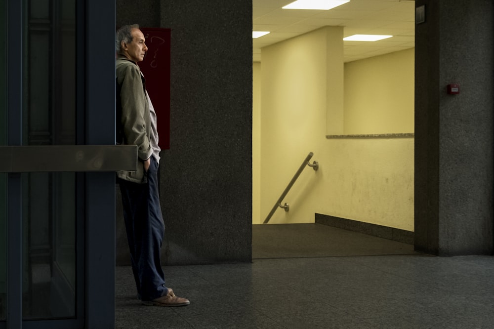 man leaning on wall