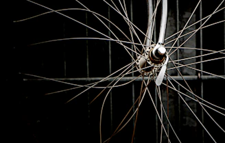 A hyperrealistic carbon fiber wheel spinning slowly against a deep black background with subtle metallic reflections