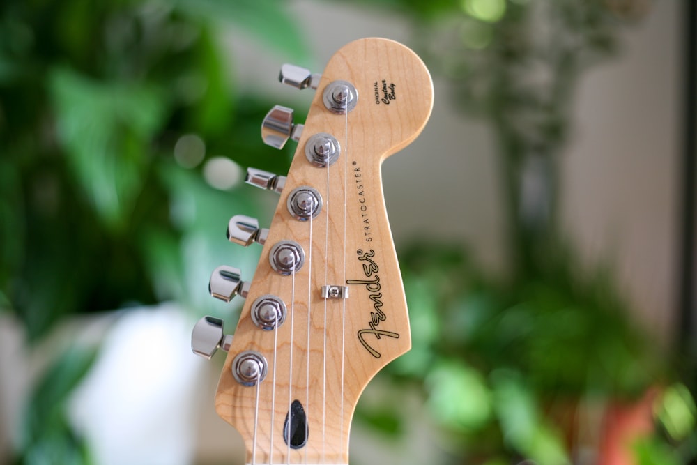 selective focus photography of guitar head