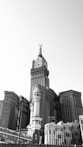 grayscale photo of buildings and a tower