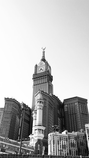 grayscale photo of buildings and a tower