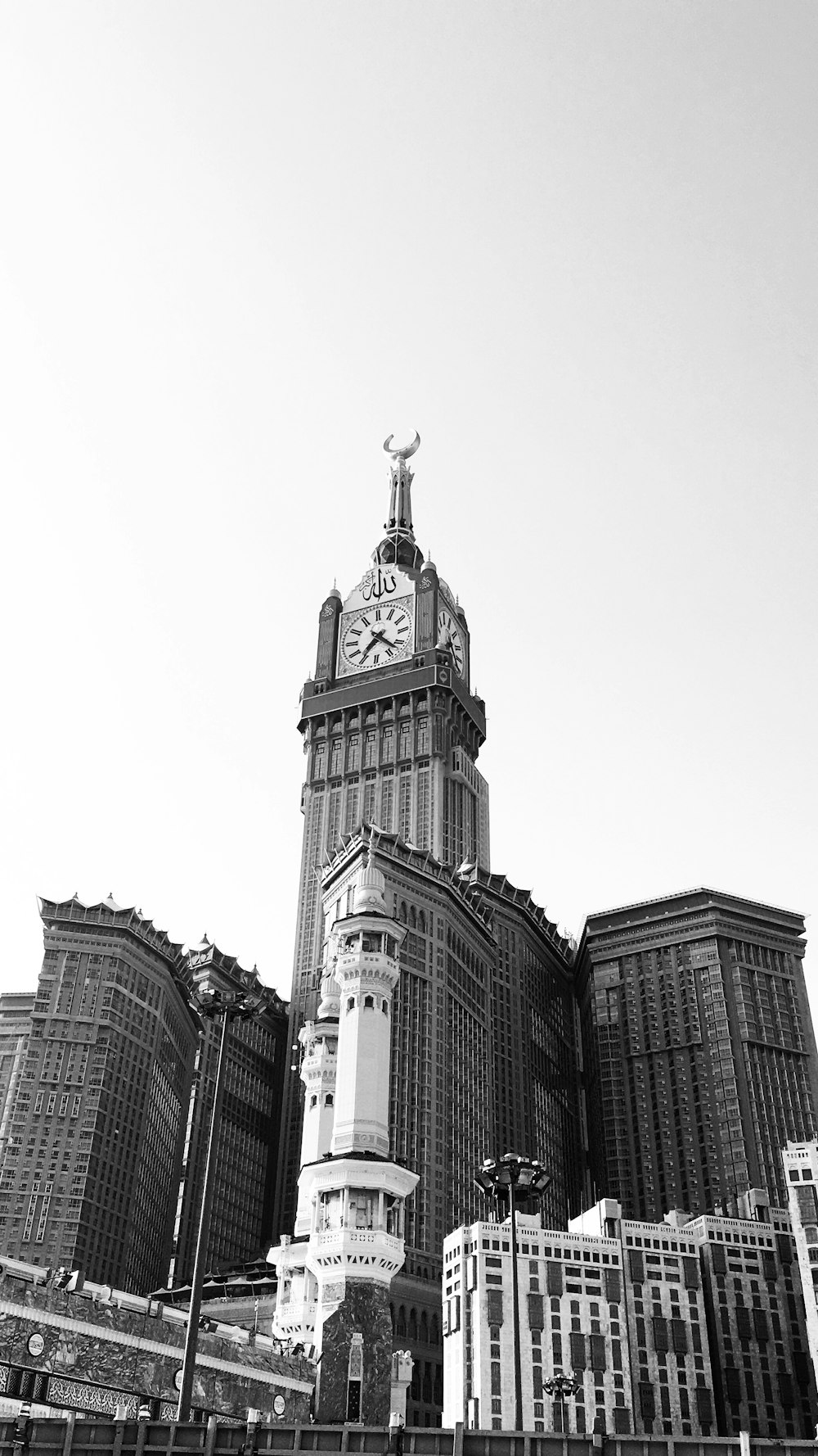 grayscale photo of buildings and a tower