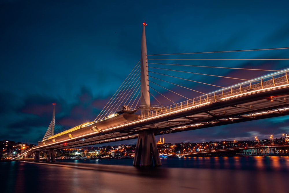 a bridge with a train going over it at night