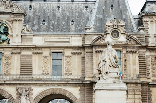 beige concrete building at daytime in Tuileries Garden France