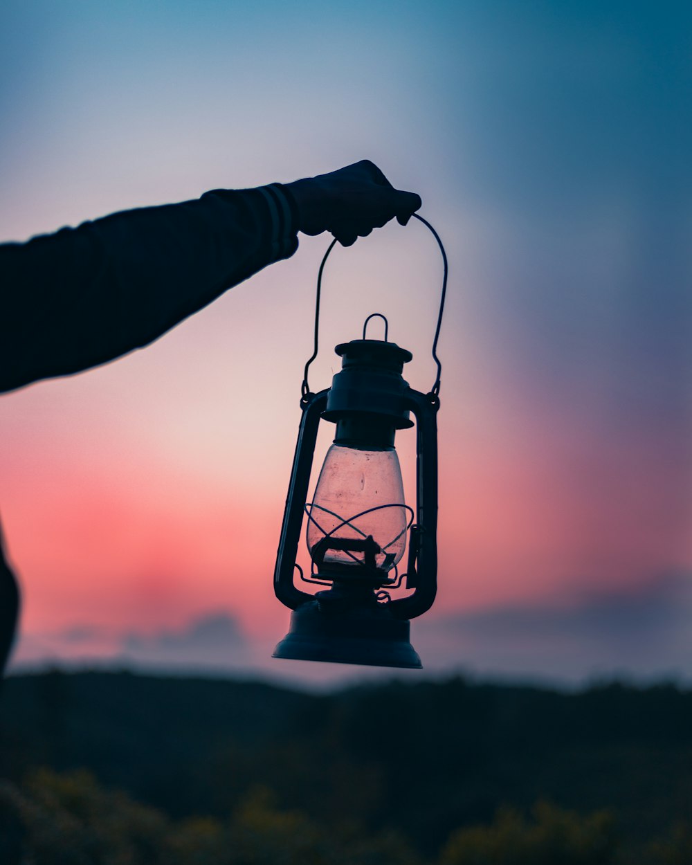 person holding gray gas lamp