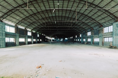 Interior shot showing high ceilings and open floor space in the Hungarian warehouse.