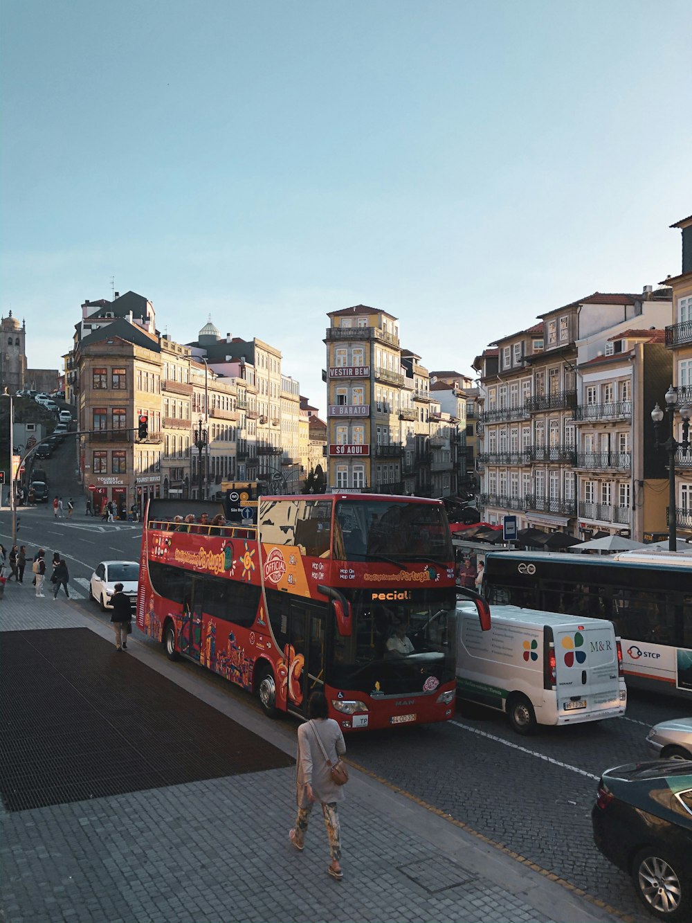 person walking on street near double-deck bus