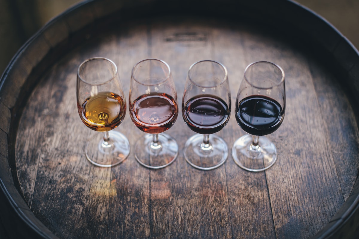 Wine of various colors on the head of a barrel. Photo by Maksym Kaharlytskyi / Unsplash