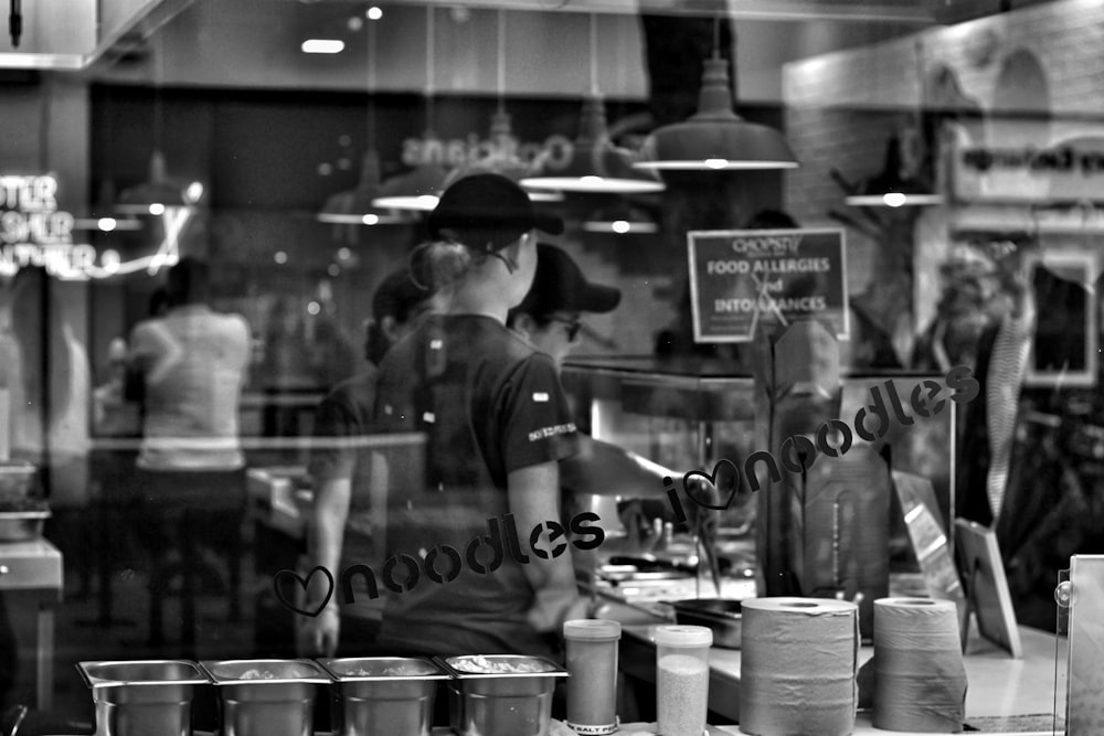 grayscale photography of people inside building