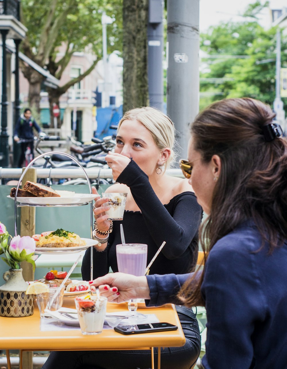 2 women sitting in front of table