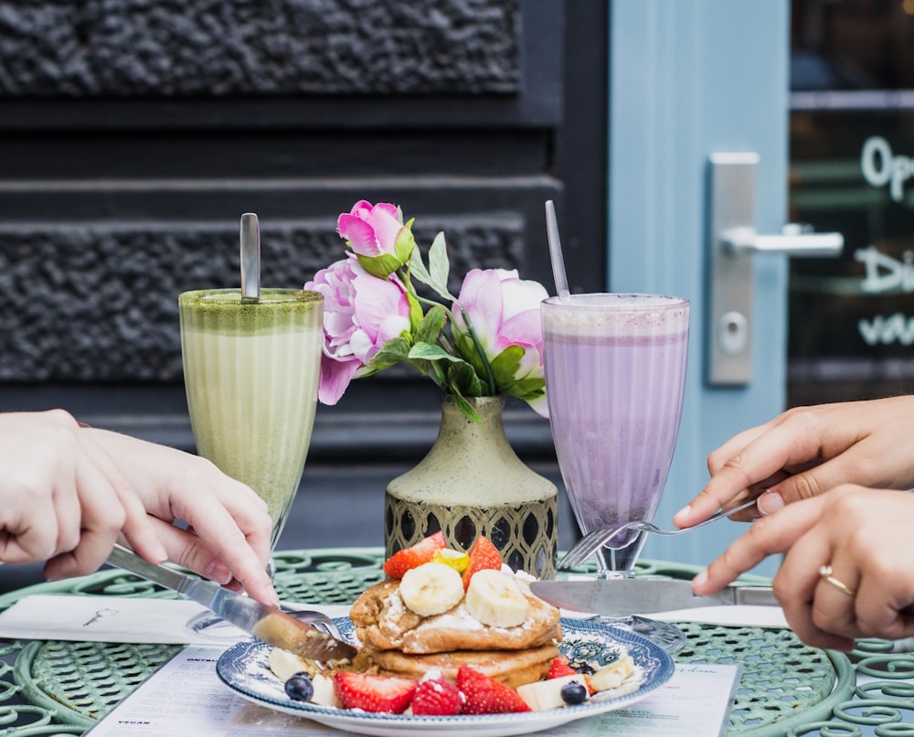 person holding fork and waffle