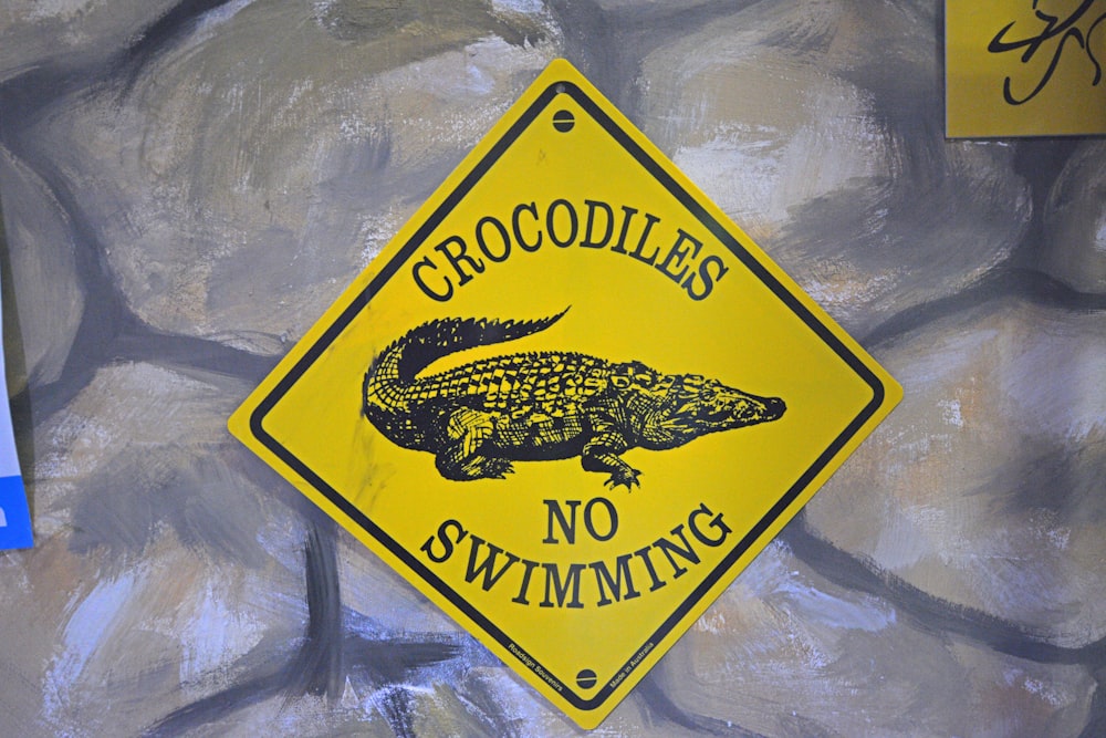 Crocodiles now swimming signage