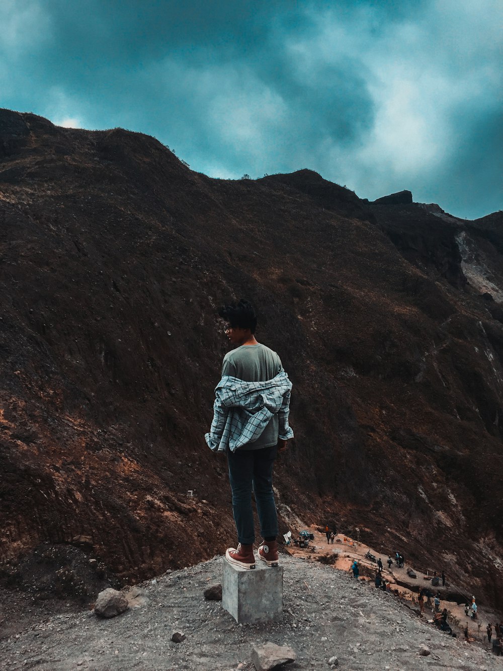 man standing on peak at daytime