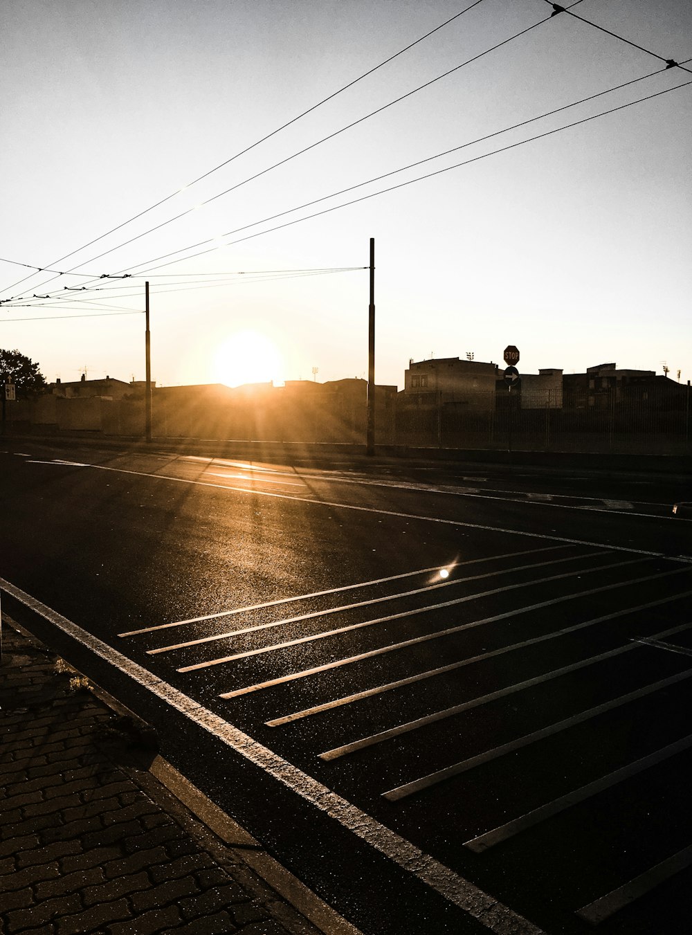 sun rays coming through houses and road