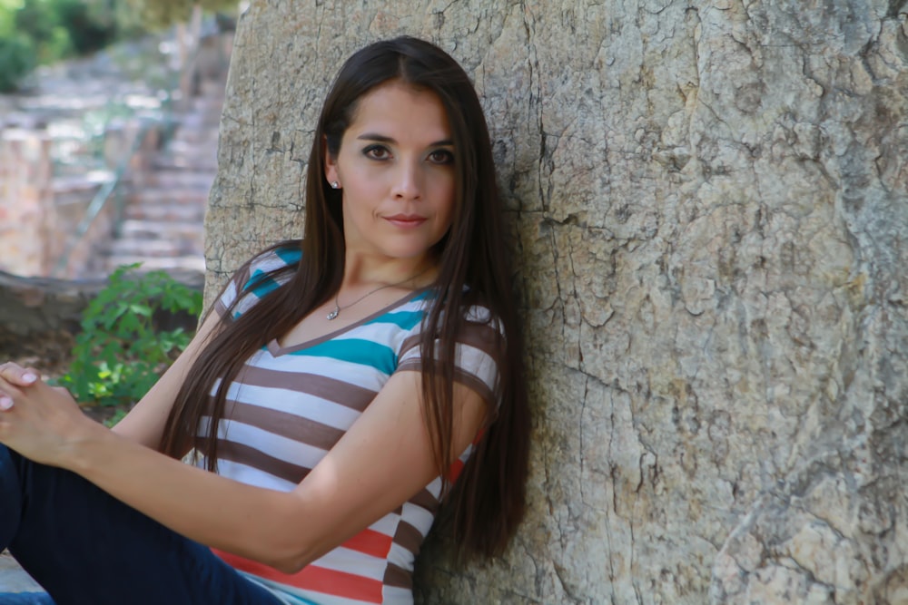 shallow focus photo of woman in white, black, and teal striped V-neck T-shirt