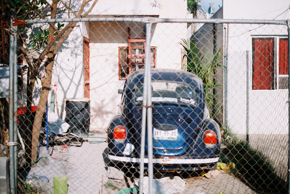 blue Volkswagen Beetle parked during daytime