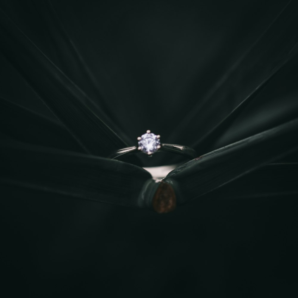 silver-colored solitaire ring