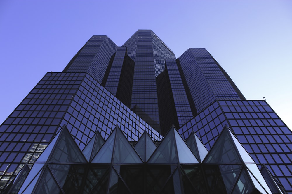 low-angle photography of blue high-rise building under blue sky