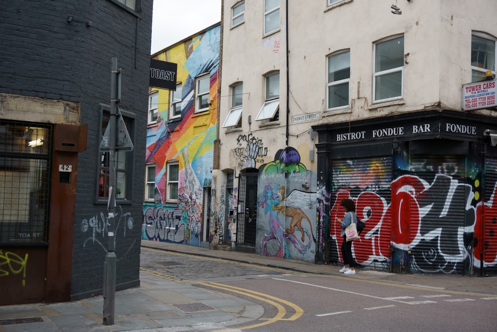 white concrete building with multicolored graffiti art