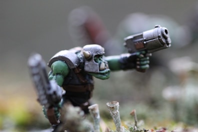 gray and green robot plastic toy