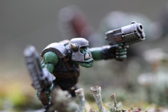 gray and green robot plastic toy