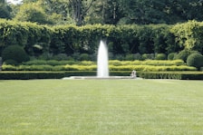 Well-maintained garden area with seating spaces and lush greenery.