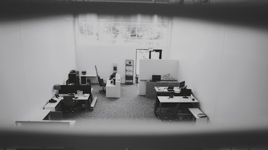An office space being cleaned thoroughly by a cleaning service team.