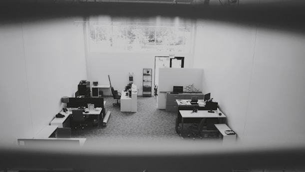 Aerial view of a professional office workspace with documents and technology.