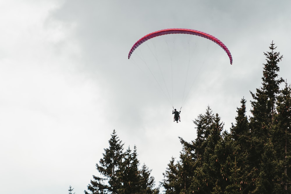 man using a pink parachute