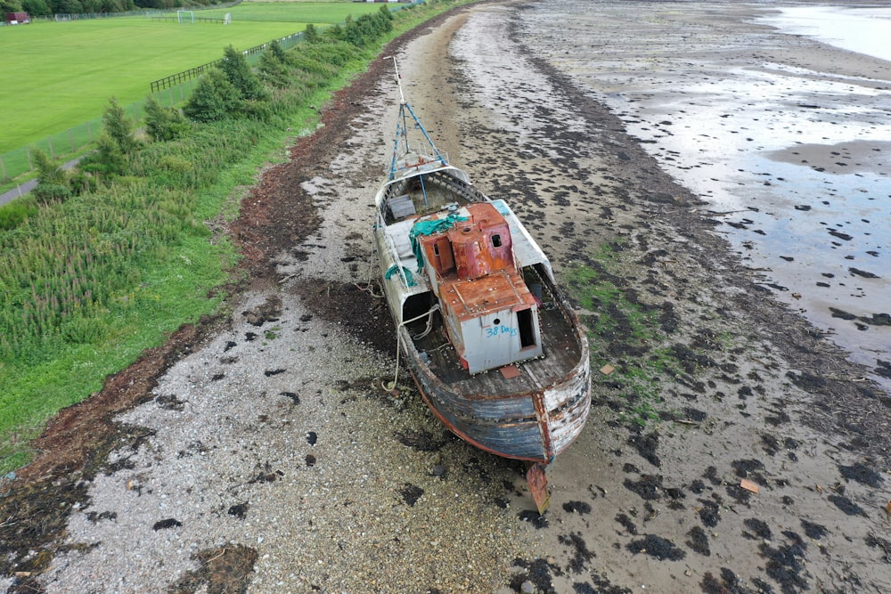 brown and grey boat in seashore
