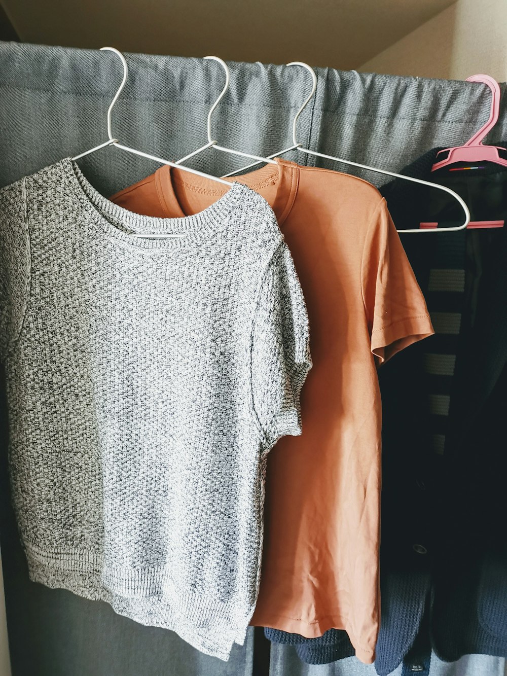 three assorted-color shirts